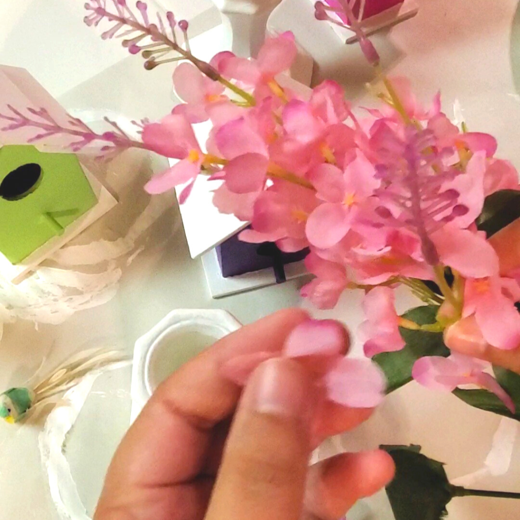 These DIY Decorative Candlestick Birdhouses are the perfect Spring decor DIY! Make your own beautiful Spring decor DIY with this step by step tutorial! Here, craft store faux flowers are used to add some extra Spring flair to the decorative birdhouses. 