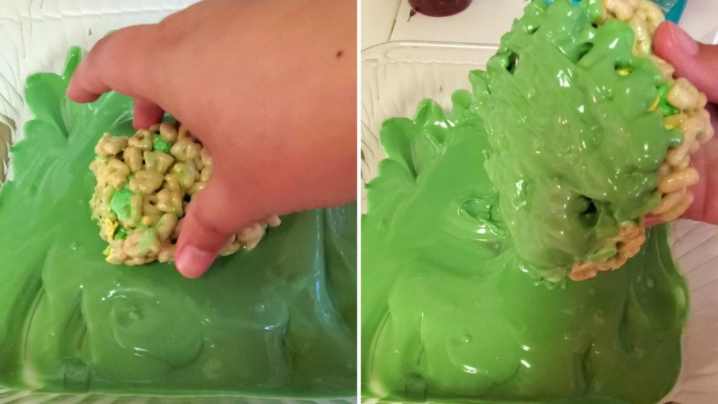 A fun St. Patrick’s Day take on the traditional Rice Krispies Treats, these Lucky Charms Marshmallow Treats are the perfect easy-to-make, no-bake dessert. Plus, they’re sweet, crunchy, so buttery, and have TWO kinds of marshmallows! Yum!
Here, dip the bottom of the Lucky Charms Marshmallow Treats into the melted candy wafers. Set the marshmallow treats onto a parchment paper-lined baking sheet.