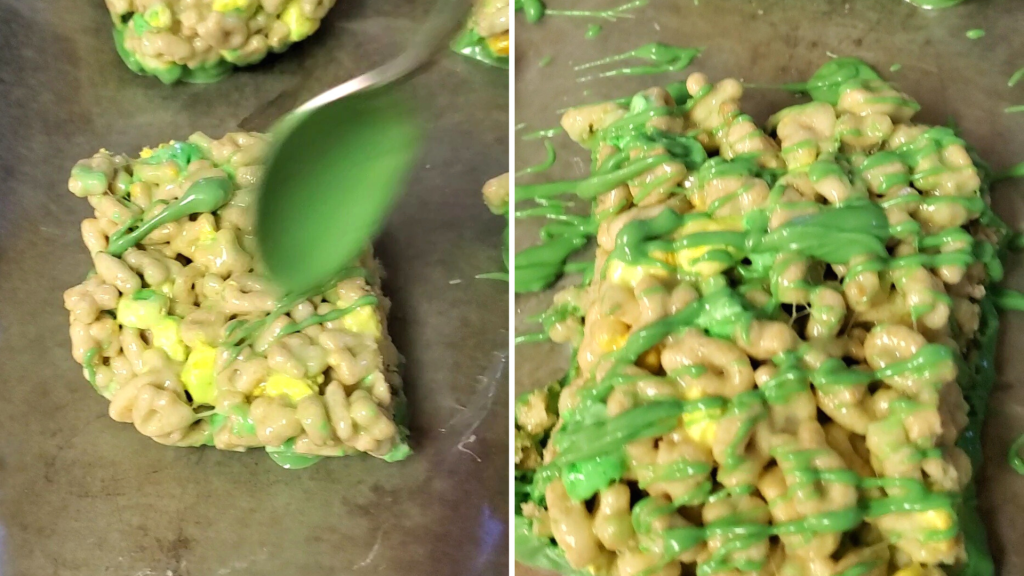 A fun St. Patrick’s Day take on the traditional Rice Krispies Treats, these Lucky Charms Marshmallow Treats are the perfect easy-to-make, no-bake dessert. Plus, they’re sweet, crunchy, so buttery, and have TWO kinds of marshmallows! Yum!
Here, drizzle the remaining melted candy wafers over the Lucky Charms Marshmallow Treats.