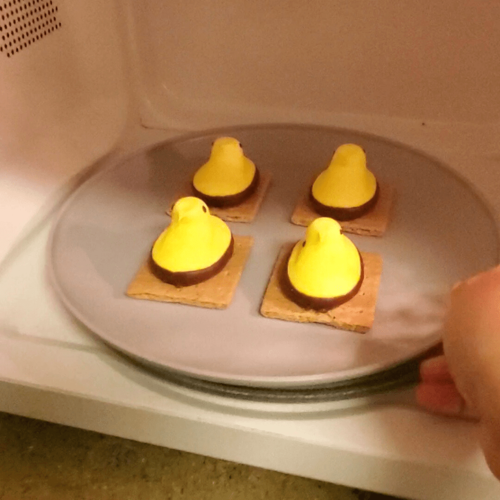 These Peeps S'mores make for a quick and easy spring treat! 
Here, place the Peeps marshmallow and graham cracker pairs into the microwave and heat on 10-second intervals. 