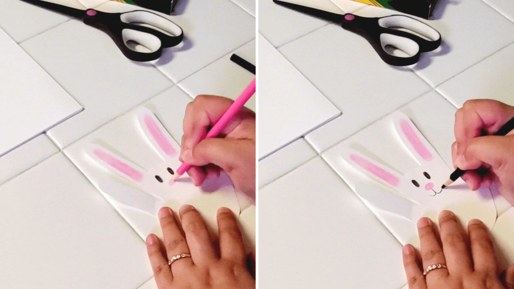 A fun and easy spring craft for families, these adorable bunnies are made out of your handprint!
Here, create the bunny's nose with a pink colored pencil. With a black colored pencil, make the bunny's mouth starting from the base of the bunny's nose. 