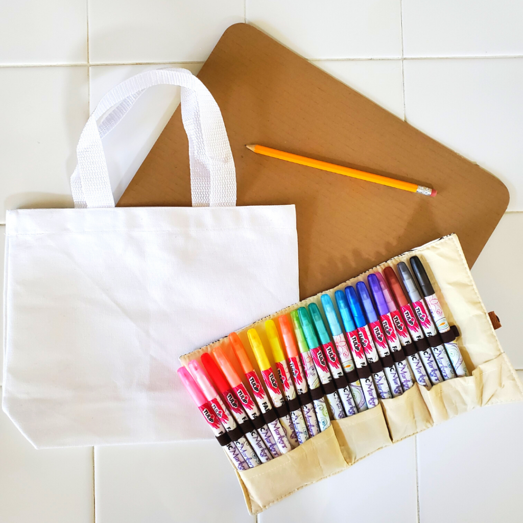 This DIY Bunny Bag is a fun spring statement piece and pairs perfectly with your spring or Easter outfit. Plus, this DIY Bunny Bag could easily be used as an Easter basket for kids to get their spring treats in and later use while Easter egg hunting!
For this project, you'll need a white canvas bag, fabric makers, a piece of cardboard, and a pencil.