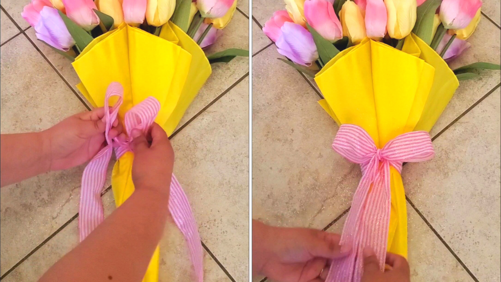 This quick and easy spring decor DIY Floral Umbrella Wreath is the perfect spring wreath for your home! Only requiring an umbrella, faux flowers, and ribbon, this spring decor DIY will add a festive touch to your entryway. 
Here, tie the ribbon into a decorative bow. 